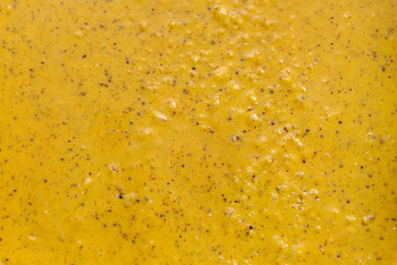 Cream honey. Honey with pollen. Body scrub, yellow color. Background, texture, close up.
