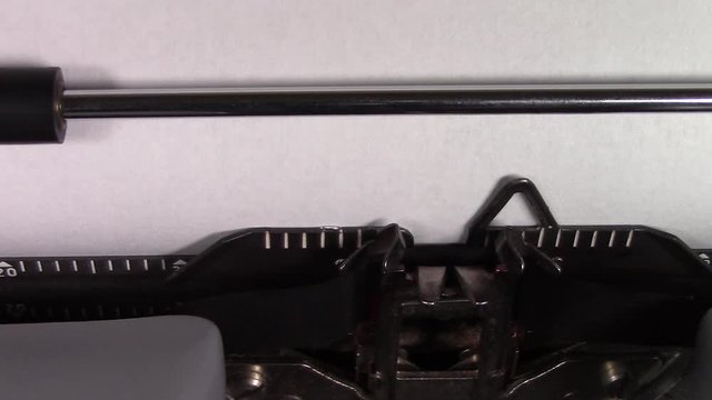 A close up video of the words "Philosophy 101 " being typed on white paper in an old manual typewriter. Shot in macro.