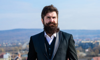 Invest in stylish appearance. Grow thick beard fast. Man bearded hipster wear formal suit blue sky...