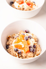 oatmeal with fruit and coffee for breakfast on a white background