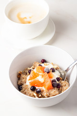 oatmeal with fruit and coffee for breakfast close-up