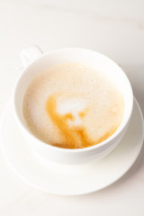 cappuccino coffee in a white mug on a close-up