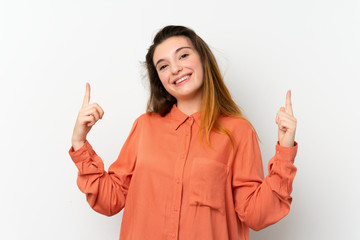 Young brunette girl over isolated white background pointing up a great idea