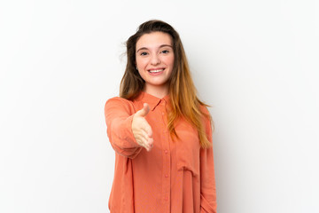 Young brunette girl over isolated white background shaking hands for closing a good deal