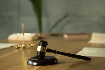 Symbol of law and justice on wooden table in lawyer office