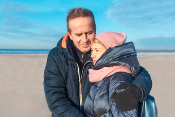 Happy nice elderly senior mature married couple in love walking, enjoying  together on the winter...