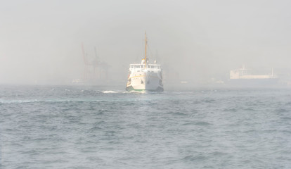 Beautiful View touristic landmarks from sea voyage on Bosphorus. Turkish steamboats hiding in fog.view on Golden Horn.