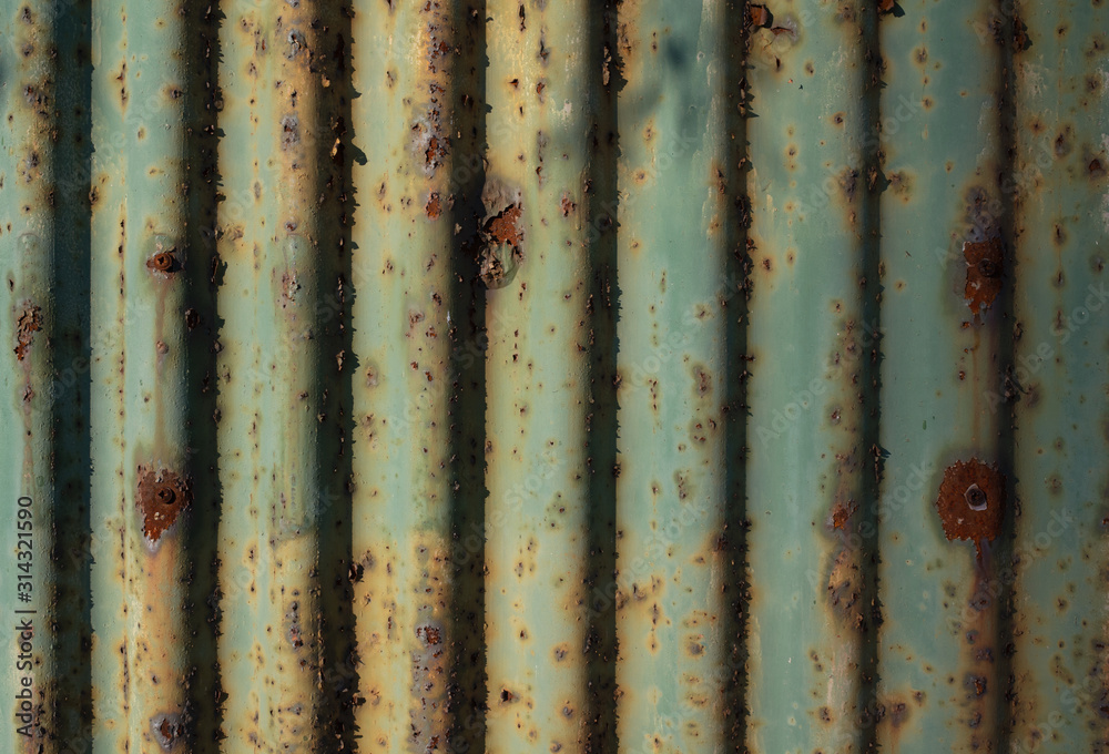 Wall mural fence and wall made of currugated iron - structure and surface of material us rusty and corroded. ol