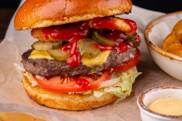 Burger with salts and ketchup with cheese and lettuce leaves