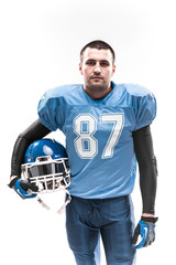 American Football Player with blue uniform on the scrimmage line. White background.