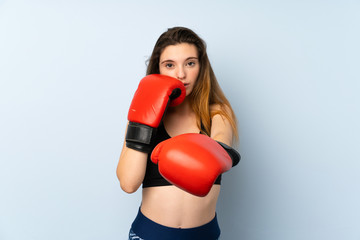 Young brunette girl with boxing gloves over isolated background