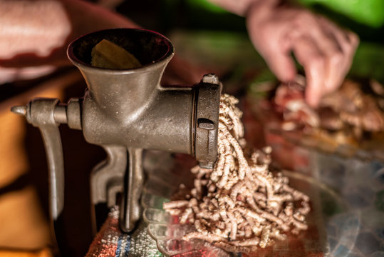  Mincing meat with an old manual mincer to fill cannelloni, typical gastornomy of Catalonia