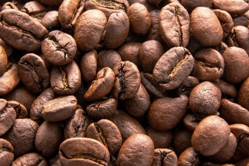 Roasted coffee beans background, top view. Copy space for text