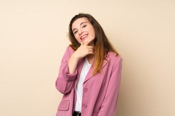 Young brunette girl with blazer over isolated background smiling