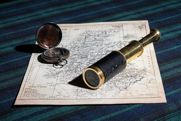 old compass, telescope and a map for navigation