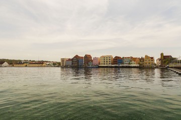 Beautiful view of coast line of Willemstad. Dark blue water surface of Atlantic ocean. Coast line...