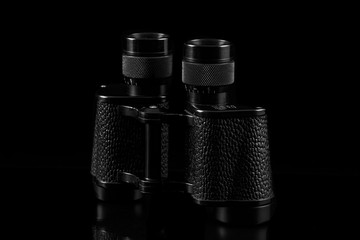 old vintage binoculars isolated on black background, travel concept.
