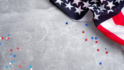 US American flag and confetti star on concrete stone background with copy space. Banner template...
