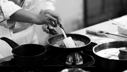 Chef cooking in a kitchen, chef at work, Black & White.