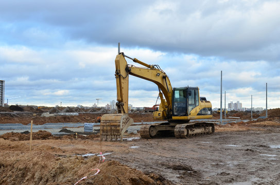 Tracked excavator working at a construction site during laying or replacement of underground storm sewer pipes. Installation of water main, sanitary sewer, storm drain systemsduring - Image
