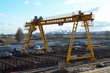 Gantry crane working at construction site. Digging a pit for the building of an underground tunnel of the metro line. Subway construction project, Minsk, Belarus, Aerodromnaya street