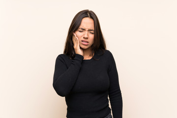 Young brunette woman with white sweater over isolated background with toothache