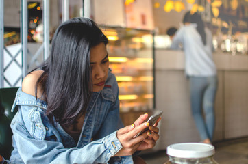 girl using smart phone in cafe