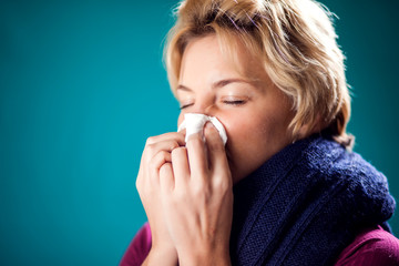 Woman got the flu, blowing nose into napkin. People, healthcare and medicine concept