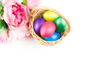 happy Easter, colored eggs in a basket and spring flowers on a white background, spring Orthodox Christian and Catholic holiday, banner with space for text