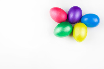 happy Easter, colored eggs in a basket and spring flowers on a white background, spring Orthodox Christian and Catholic holiday, banner with space for text