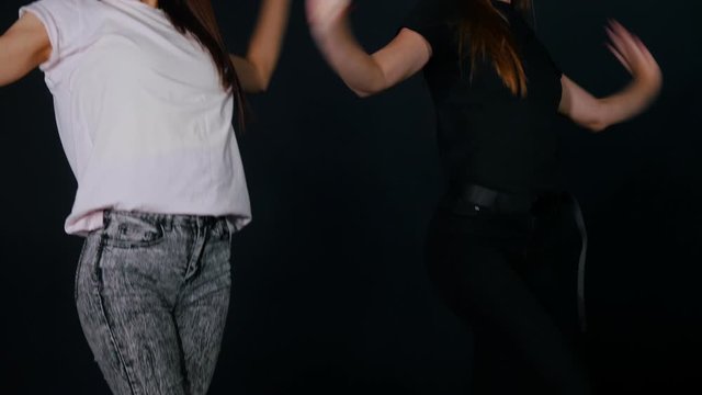 Two young women dancing vogue