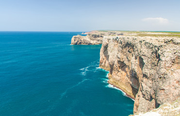 Fototapeta na wymiar Portugal, Algarve, view of famous cliffs of Moher and wild Atlantic Ocean, Portuguese coastline close to Cape St. Vincent on a sunny and clear day with The blue Atlantic in the background