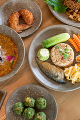 Rice mixed with Mackerel Chili Paste with other food on wooden table