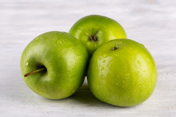Apples green on white wooden background