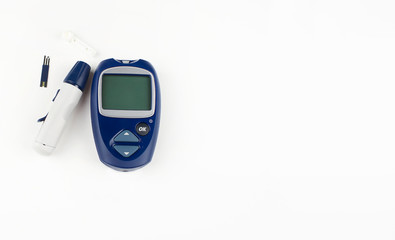 device for measuring blood sugar-blood glucose meter, syringe pen and test strip on a white...