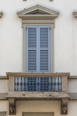 balcony with grey shutters of ancient house Como, Europe