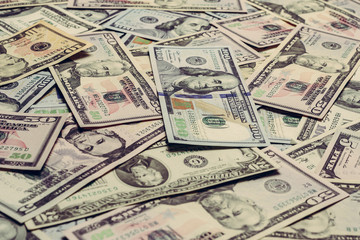 Close up dollar texture, dollars in denominations of five, ten, twenty, fifty, one hundred.