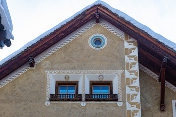 wooden mountain house facade, with snow-covered roof, Swiss