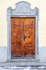 wooden door with ancient stone decorations, Swiss
