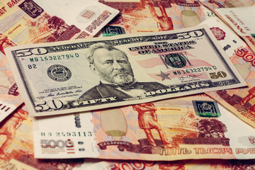 50 dollars on the background of Russian notes in the amount of 5000 rubles