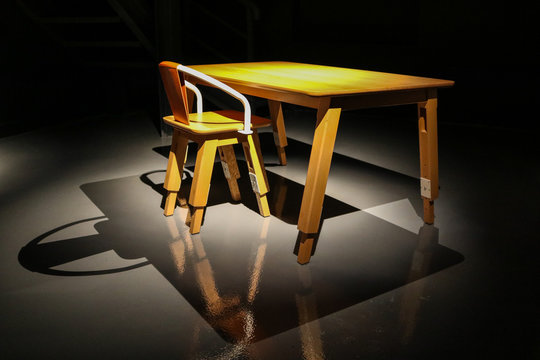 the chair and table  made by wood under the spotlight