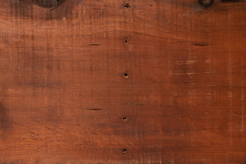 Brown wood background with scuffs and scratches. Wood texture.
