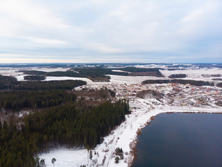 Winter nature, forest, river, village. View from above. Shooting from a copter.