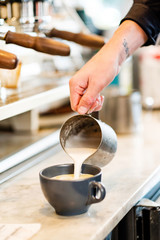 Fototapeta na wymiar Barista making coffee latte