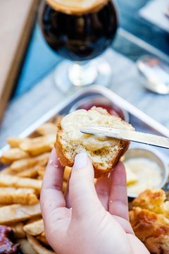 Hand Spreading Butter On A Roll