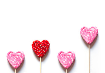 Heart shape pink and red lollipop on the white background. Valentine's day greeting card