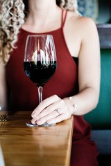 Young woman holding a glass of red wine