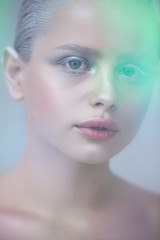 Naklejka premium Artistic photo of a girl with winter make-up. Frozen girl with snowy eyelashes and eyebrows.