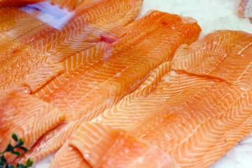 Raw salmon Fish fillet steak on ice at the fish market. Large assortment of fresh seafood, Norwegian salmon fillet. Keto food and healthy nutrition concept.