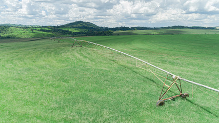 Agricultural irrigation system on sunny summer day. An aerial view of a center pivot sprinkler system.